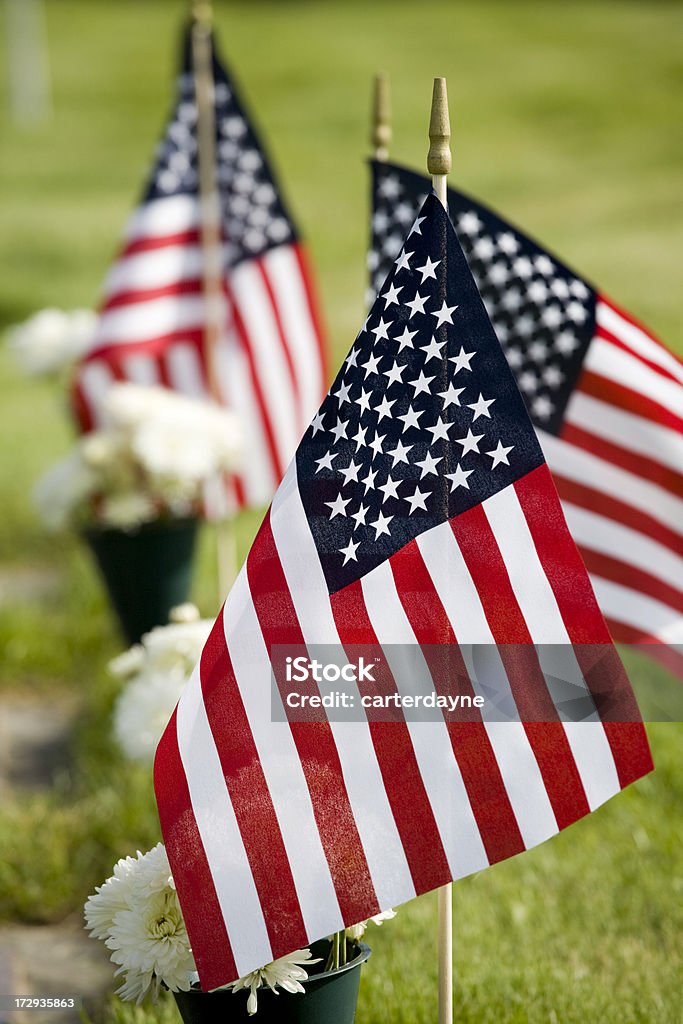 Memorial with white cross and US flag Memorial day graveyard with white crosses and the US flag. American Flag Stock Photo