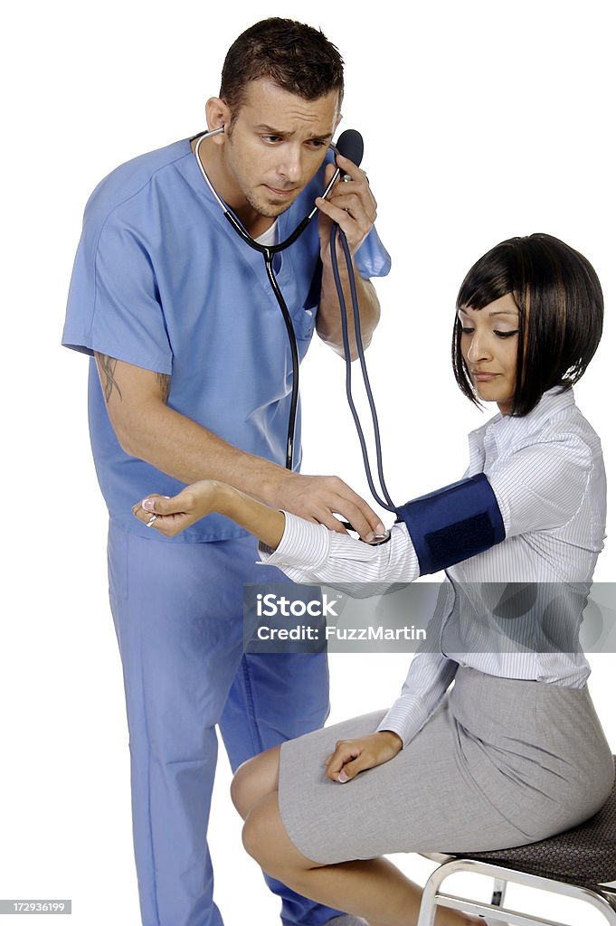 Taking BP A young male nurse takes a woman's blood pressure.  Beauty Stock Photo