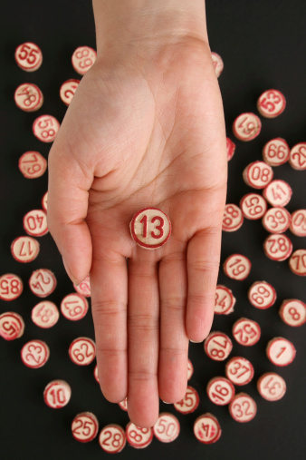Top view of woman hand holding number 13.