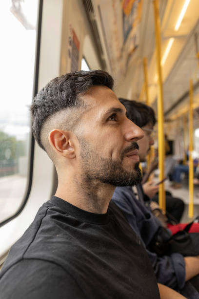 istock Hispanic man riding the subway sitting relaxed 1729374823