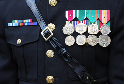 Military dress uniform with many medals and ribbons.