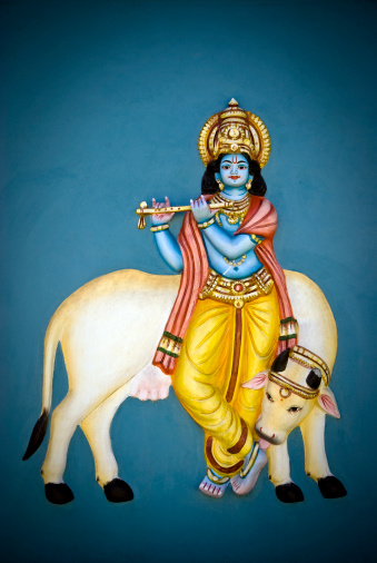 Painting of god Krishna with a sacred cow on a Tamil temple' wall located in Mauritius island