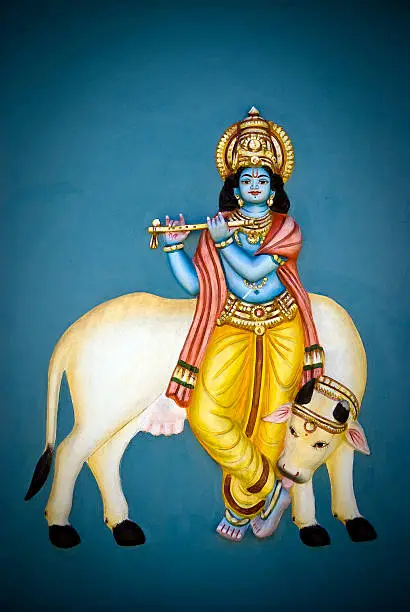Painting of god Krishna with a sacred cow on a Tamil temple' wall located in Mauritius island