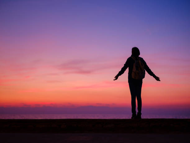istock Woman tourist against sunset sky 1729399867