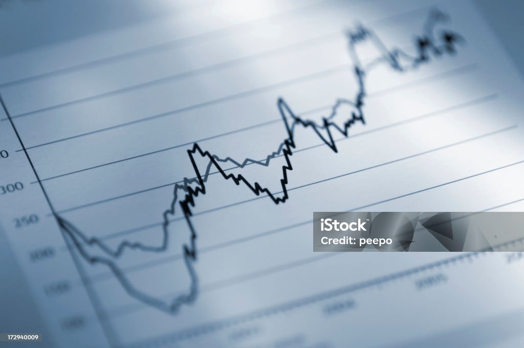 Close Up Of Business Chart blue tinted selective focus image of part of stock price graph Blue Stock Photo