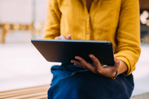 istock An Unrecognizable Woman Working On Her Tablet While Sitting Outdoors 1729401983