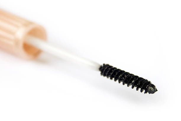 istock Black mascara applicator against white background, close-up 172940388