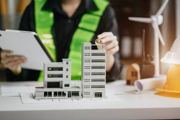 istock architect hands making model house. Man architect working in the office. 1729424251