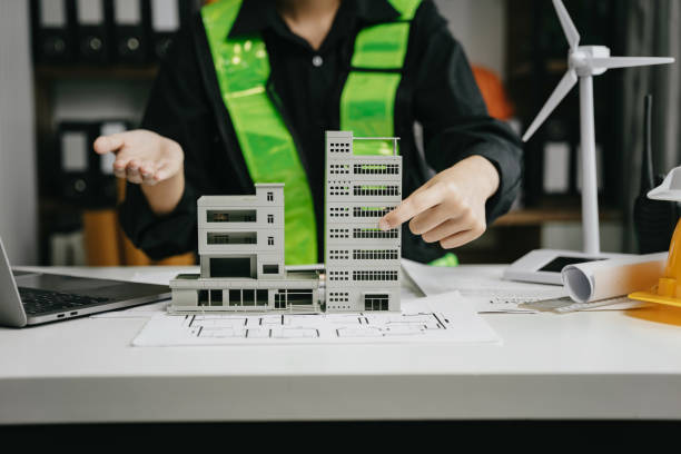 istock architect hands making model house. Man architect working in the office. 1729424256