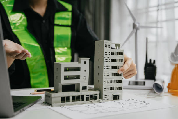 istock architect hands making model house. Man architect working in the office. 1729424258