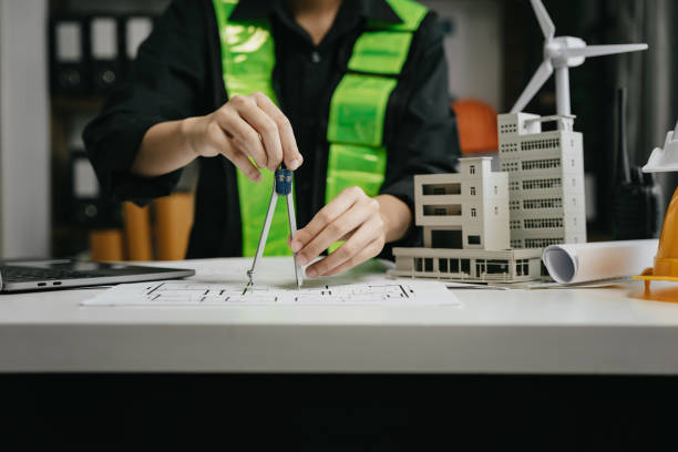 istock architect or engineer working on table use drawing tool on the paper plan for business architectural project. 1729424267