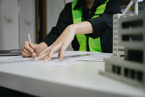 istock architect or engineer working on table use drawing tool on the paper plan for business architectural project. 1729424271