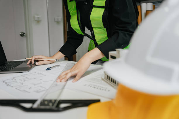istock architect or engineer working on table use drawing tool on the paper plan for business architectural project. 1729424791