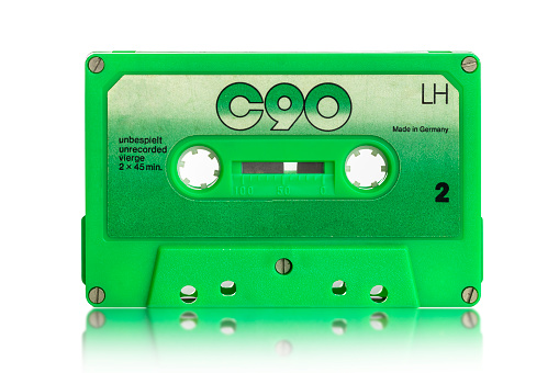 old black audio cassette on a white background