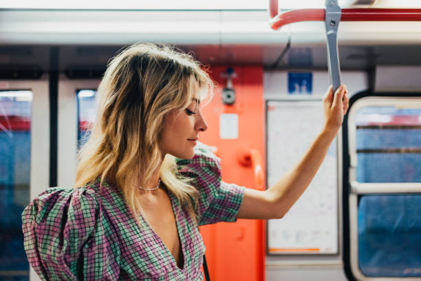 istock Attractive Woman Looking Away while Standing in the Underground Train 1729432456