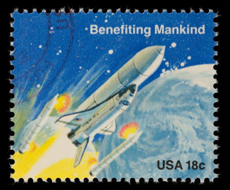 1981 US postage stamp depicting a space shuttle ejecting its solid rocket boosters. A cloudy Earth is in the background. Canon 40D with 100mm macro; no sharpening.