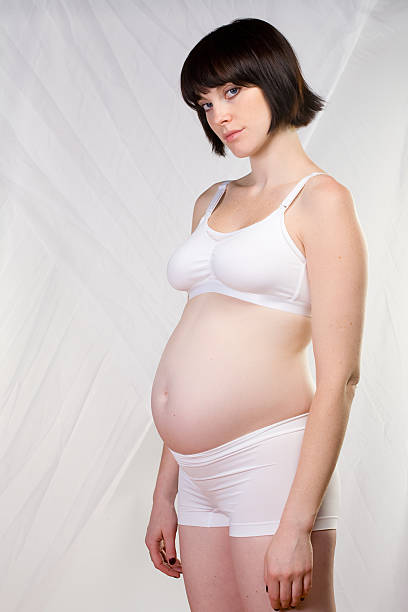 istock Pregnant woman in her underwear looking at camera 172944310