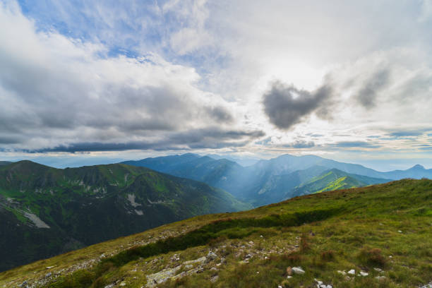 istock Landscape high in the Polish Tatras, sun rays shining through the clouds. 1729447429
