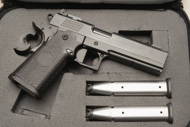 istock Pistol with ammunition magazine inside the holding case 1729451840