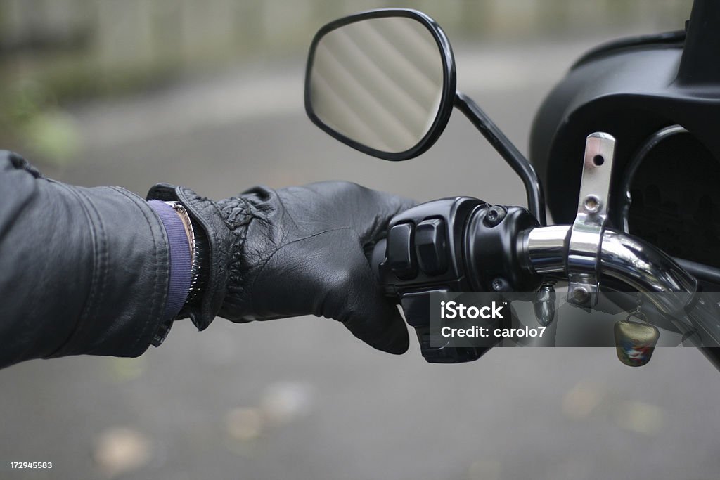 Close-up of hand on motorcycle clutch. "Close-up of hand on motorcycle clutch and biker's lucky bell.       See more of my motorcycle images, and images of this model:" Mirror - Object Stock Photo