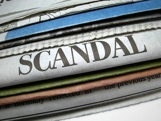 Pile of newspapers with scandal headline prominent stock photo