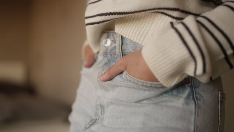 Close-up of a womans hands in her pockets