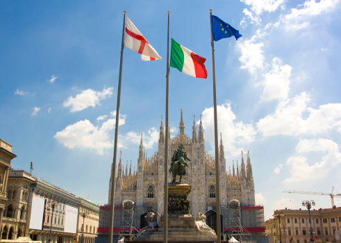 Duomo di Milano and the three flag of the region: european,italian and lombardy