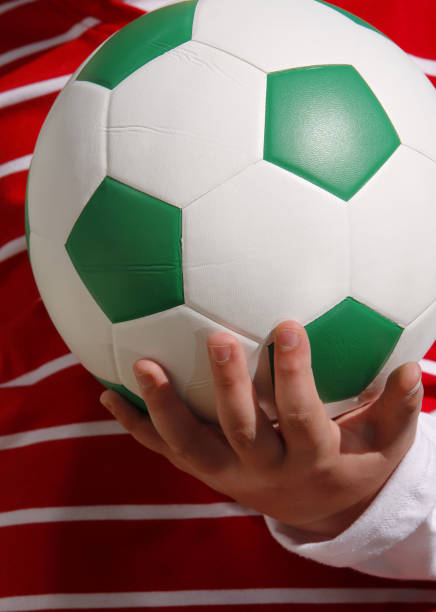 istock Schoolboy holding a soccer ball 172946667
