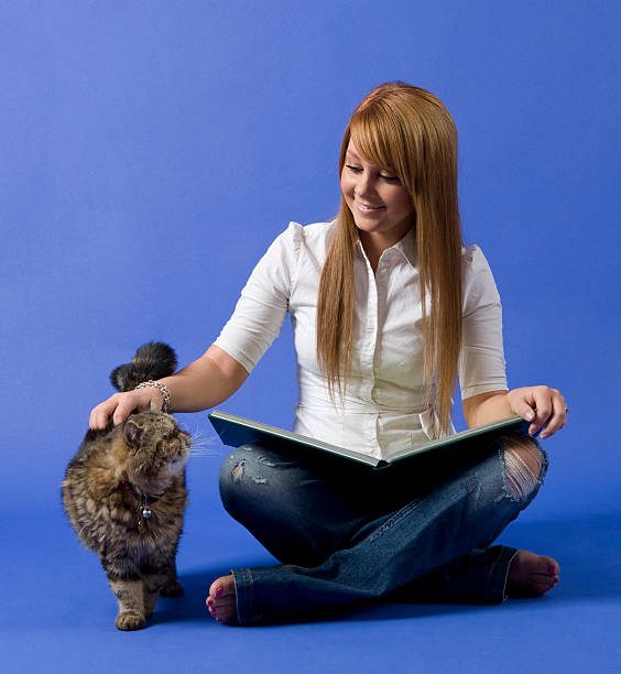 istock girl reading and petting cat 172946676