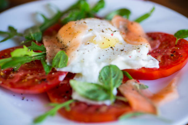 istock Cooked poached egg with herbs, lightly salted salmon and tomatoes with spices . 1729467597