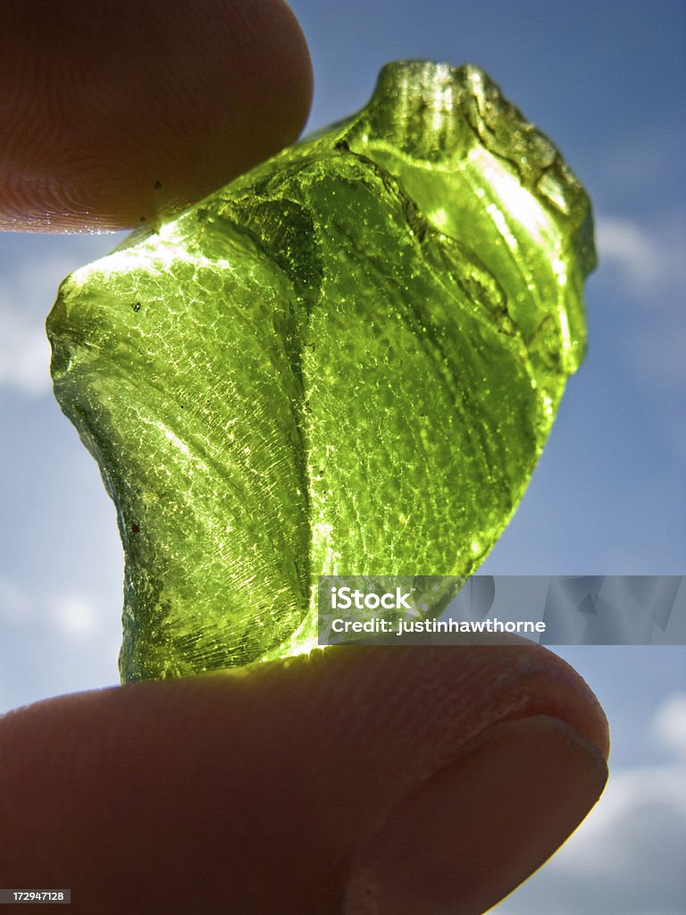 Recycling Hand holding bottle glass at a recycling facility. Business Stock Photo