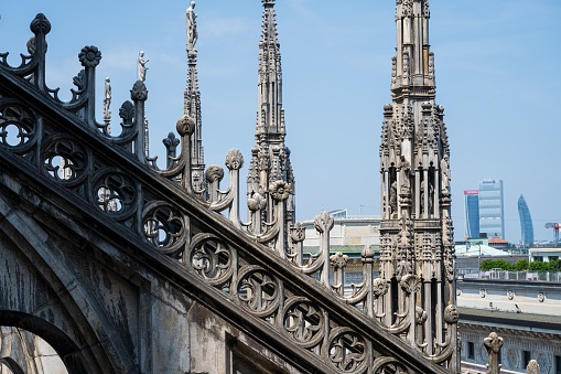 MIlan, Italy – June 18, 2023: A detail of the Milan Cathedral with the city in background in Italy