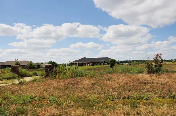 Photo of Overgrown Foreclosed Home and Property