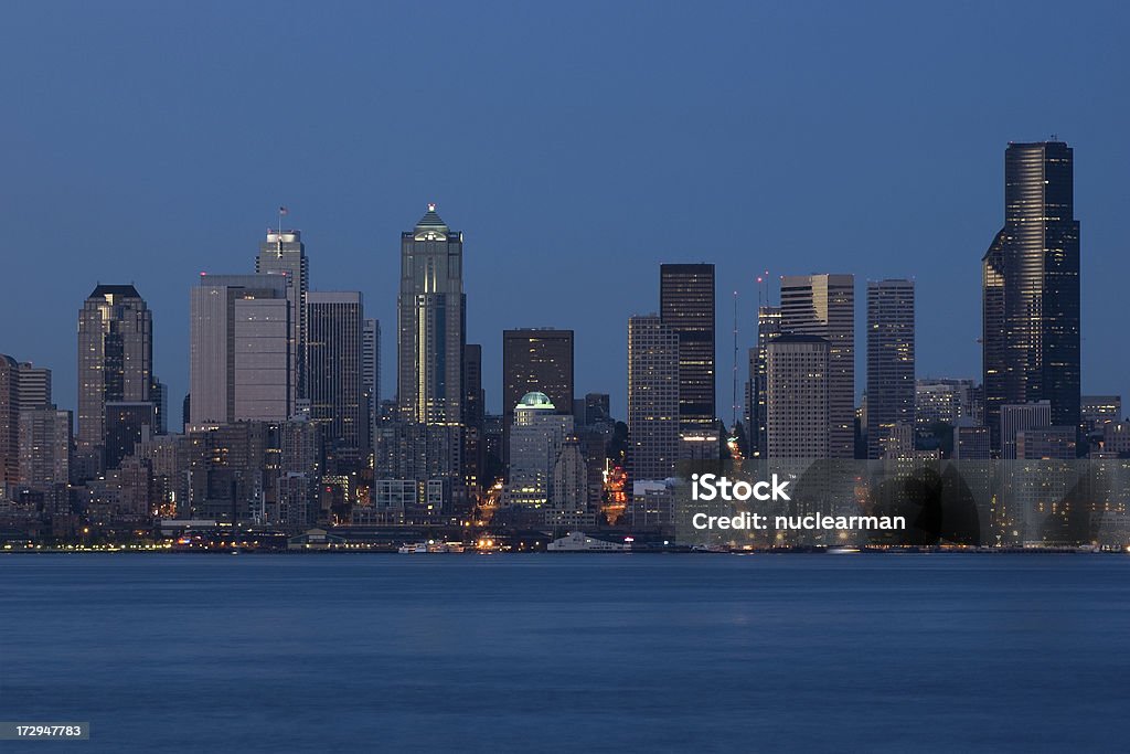 Downtown Seattle Skyline "A shot of the waterfront and downtown Seattle skyline taken from West Seattle.  Columbia Center, the tallest building in the Pacific Northwest, is on the right.  The shot was taken shortly after the sun had set on a warm and cloudless summer evening (July, 2008).  Aperture is f/11, with a 3 second exposure." Blue Stock Photo