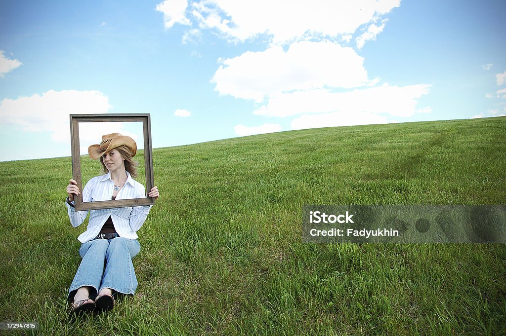 Old Frame Picture of a cowgirl holding old picture frame.See Also: Adult Stock Photo