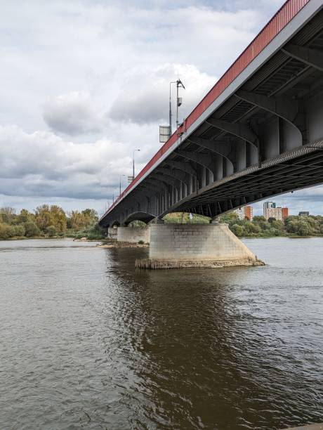 istock Underneath the bridge, the river flows gracefully, and as you look up 1729479496
