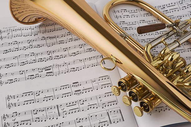 Photograph of a brass horn and music.