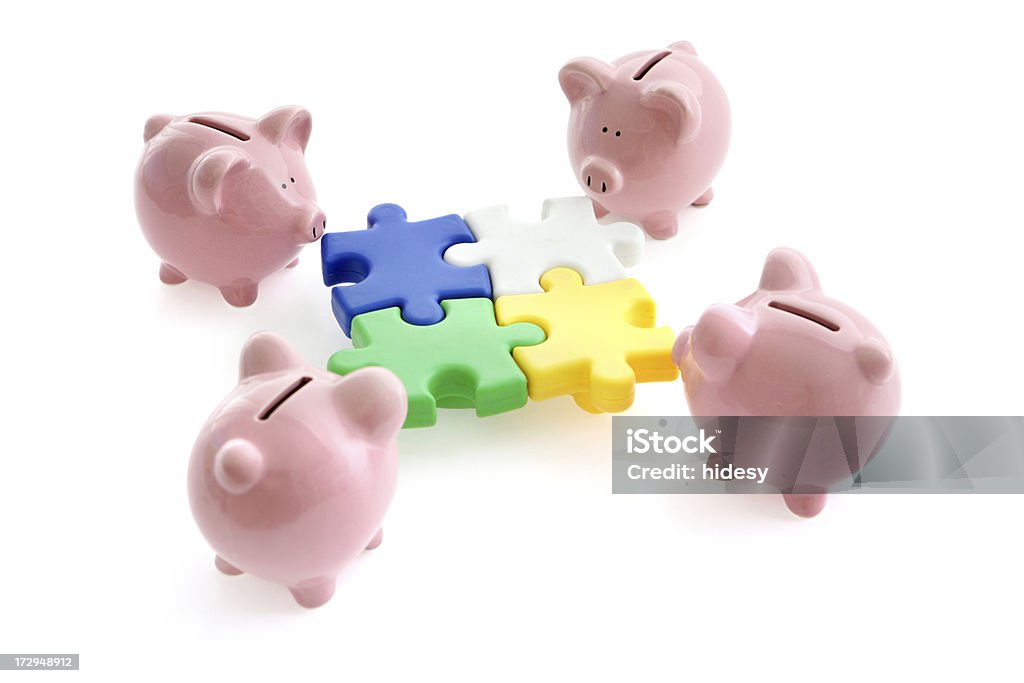 Financial Solutions Piggybanks putting a jigsaw puzzle togetherNo copyright information on piggybank or packaging Assistance Stock Photo