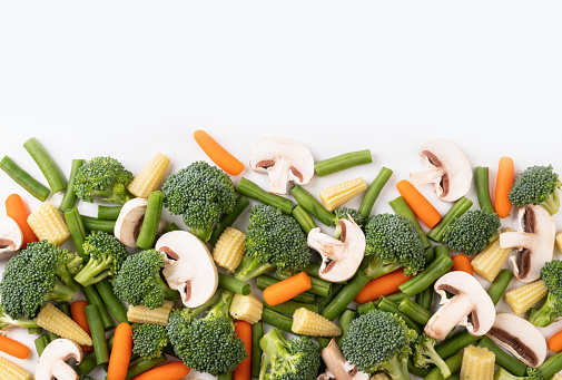 the mix raw vegetable. Flat lay of fresh raw organic vegetables on white background - broccoli, carrot, mushrooms, green beans, cauliflower, mini corn