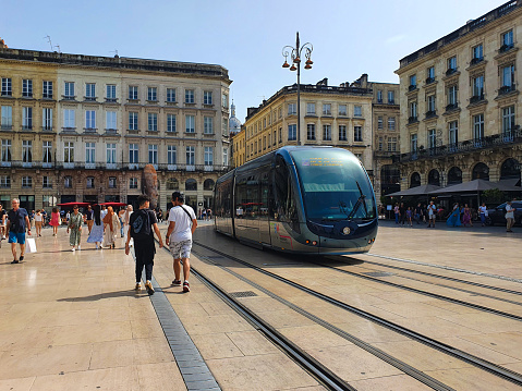 Bordeaux ,France - 21 May 2022 - view of people walking, and tramway and buildings in the main place in Historic center in Bordeaux
