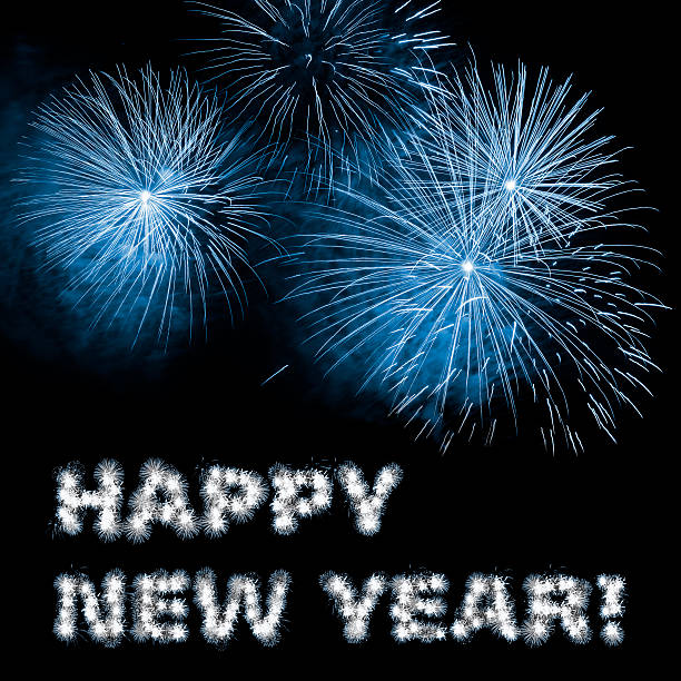 Happy New Year written letters, blue fireworks against dark sky. Night fireworks show.