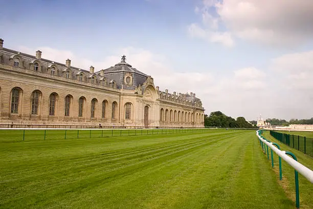 "The Living Horse Museum, Le Musee Vivant du Cheval, in Chantilly, France which houses the worldaas most beautiful stables, and probably the largest at 186mm long. They were built in 1719, could house up to 240 horses and belonged to the adjacent, Chantilly Chateau , seen in the distance, which was in the ownership of the Princes de CondA. The Chantilly racetrack runs alongside the Museum."