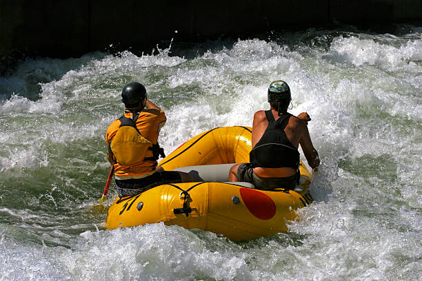 Two men white water rafting stock photo