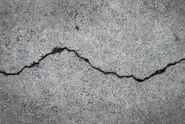 Photo of Crack in grey concrete surface