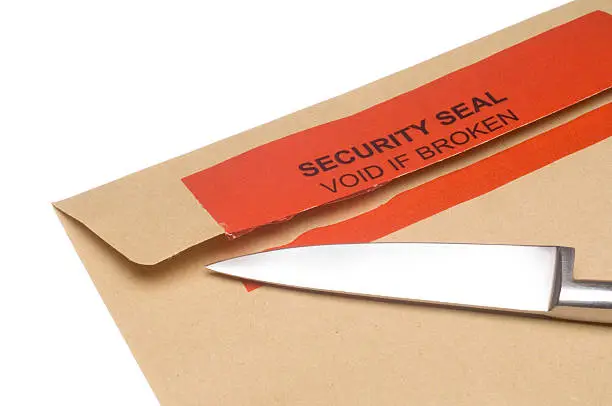 An envelope with a broken security seal