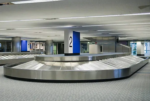 Empty baggage claim carousel at an airport.