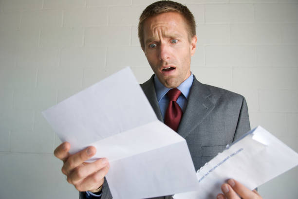 istock Businessman Opens Letter with Expression of Disbelief 172951465