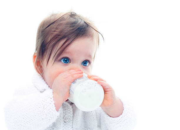 Baby with milk bottle stock photo