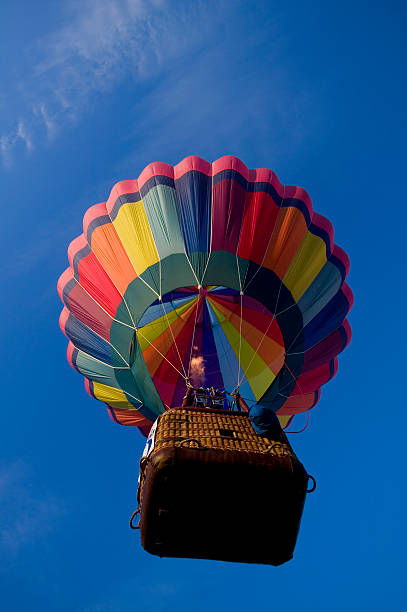 istock Hot air balloon rising into a blue sky 172951839