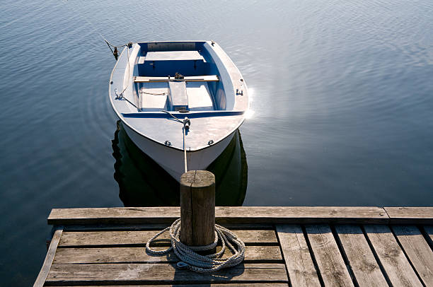 pequeno barco atracado, reflexo de luz - pier rowboat fishing wood - fotografias e filmes do acervo